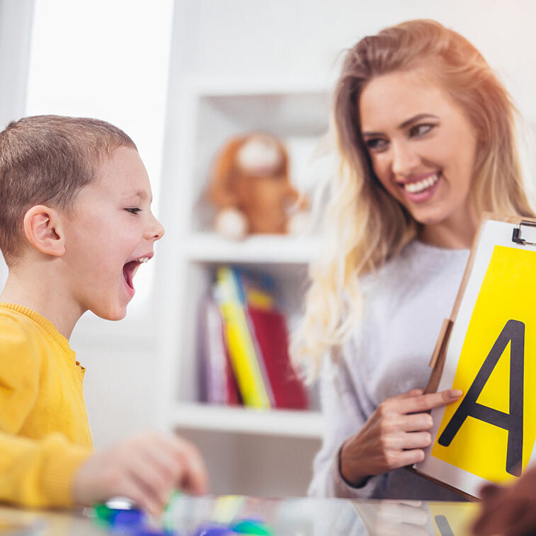 Speech therapist teaches the boys to say the letter A