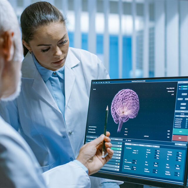 Two medical scientists discussing brain scan images
