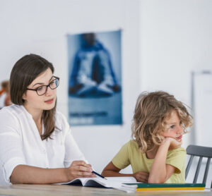 child looking away from therapist during ABA therapy