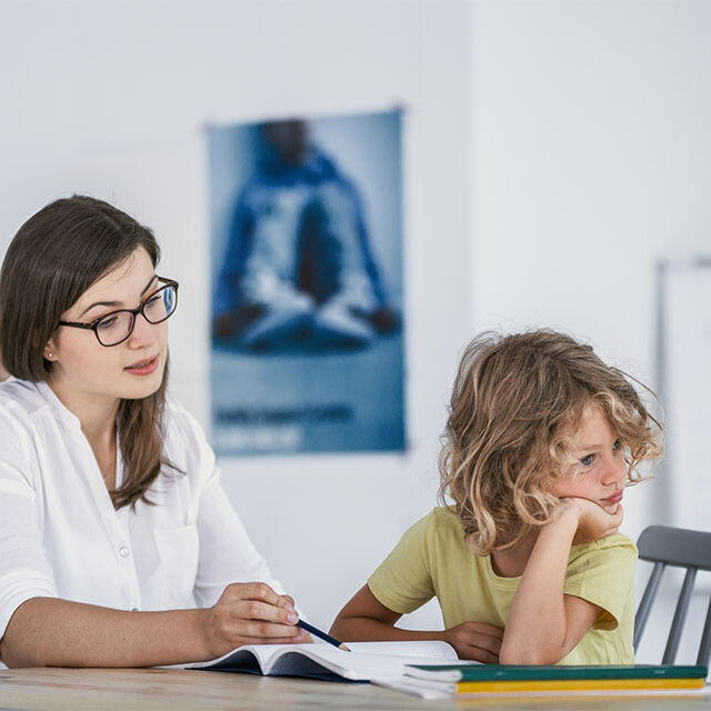 child looking away from therapist during ABA therapy